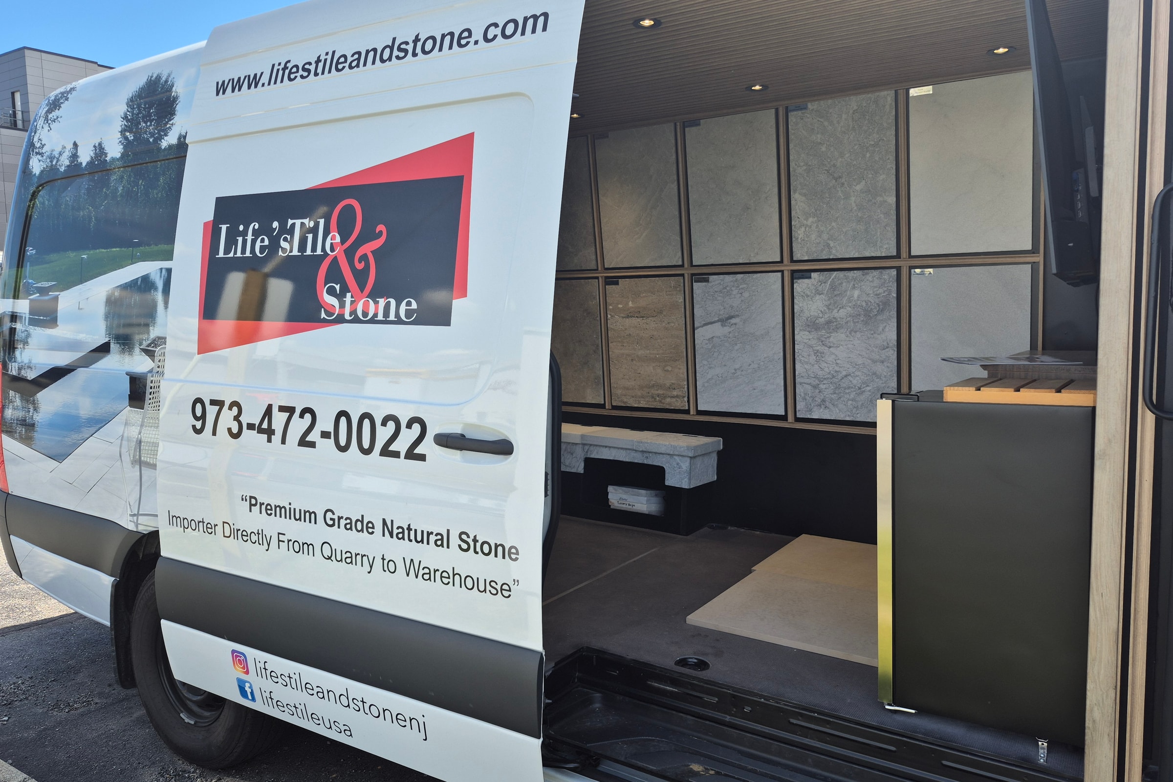 The Life's Tile & Stone Mobile Showroom with its side door open
